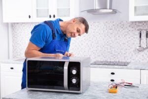 A Technician at Kitchen Highlighting Microwave Oven Repair in Keller, TX